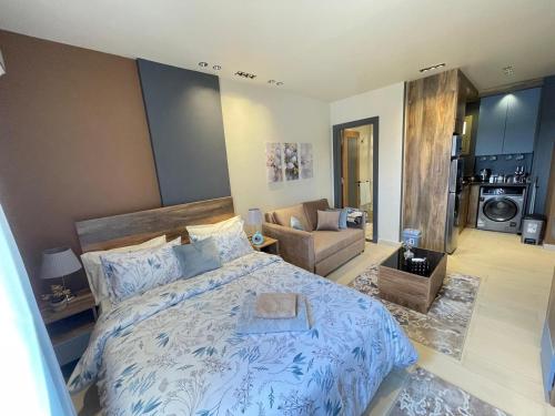 a bedroom with a bed and a living room at Luxury Studio House 392-4 in 6th Of October