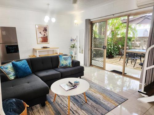 a living room with a couch and a table at Bakers Sea Breeze Escape in North Ward