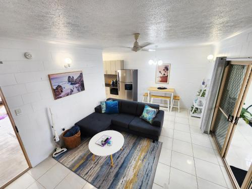 a living room with a couch and a table at Bakers Sea Breeze Escape in North Ward