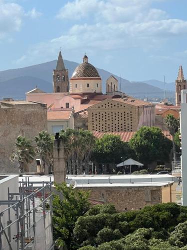 a view of a city with a train in the foreground at Blue Terrace Guest House in Alghero