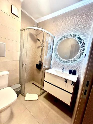 a bathroom with a shower and a sink and a mirror at Sorrento E 4 4 Sveti Vlas in Sveti Vlas