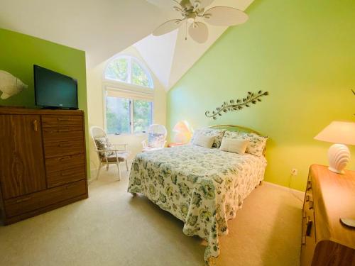 a bedroom with a bed and a dresser and a tv at Spring lake 601 in Rehoboth Beach