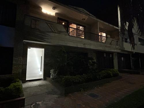 a white door in a building at night at Casa Kyros Boutique in Medellín