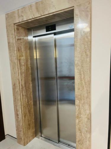 a stainless steel refrigerator in the corner of a room at Sorrento E 4 4 Sveti Vlas in Sveti Vlas