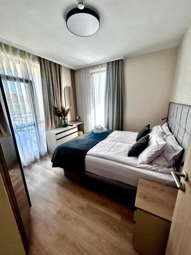 a bedroom with a bed and a large window at Sorrento E 4 4 Sveti Vlas in Sveti Vlas