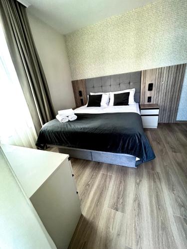 a bedroom with a large bed and wooden floors at Sorrento E 4 4 Sveti Vlas in Sveti Vlas