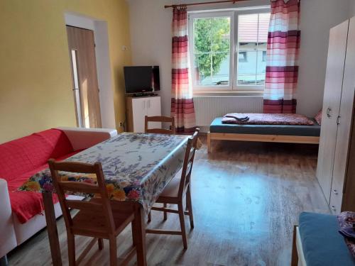 a living room with a table and a couch at Apartmány Dunice 2 - celý dům 