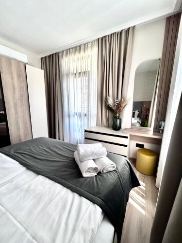 a bedroom with a bed and a vanity and a mirror at Sorrento E 4 4 Sveti Vlas in Sveti Vlas