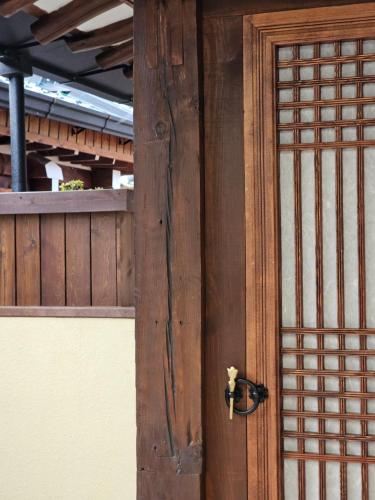 a wooden door with a handle on a building at SiEunJae in Gyeongju