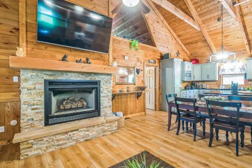a living room with a fireplace and a table and chairs at Great Smoky Mountain, Hot Tub, Mins to Dollywood in Kodak