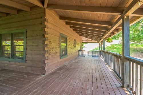 a front porch of a wooden house with windows at Great Smoky Mountain, Hot Tub, Mins to Dollywood in Kodak