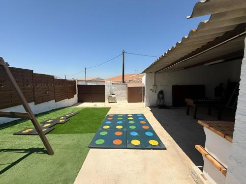 a backyard with a game of dominoes on the ground at Santinho house 2 in Beja