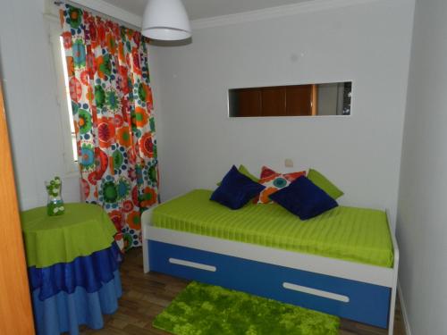 a small bedroom with a bed and a window at Sweet Home Santander in Santander