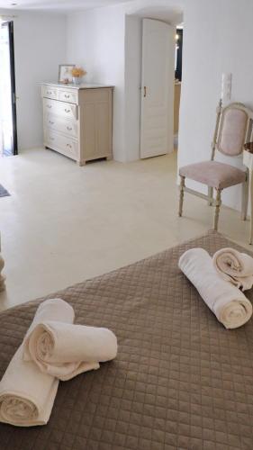 a room with a chair and towels on the floor at Anetta's House in Agia Marina