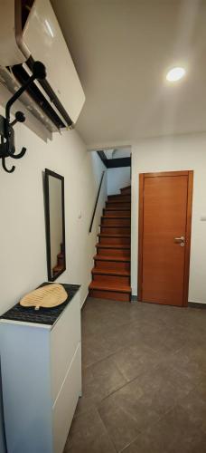 a room with a staircase and a mirror on a counter at NS Kutak in Novi Sad