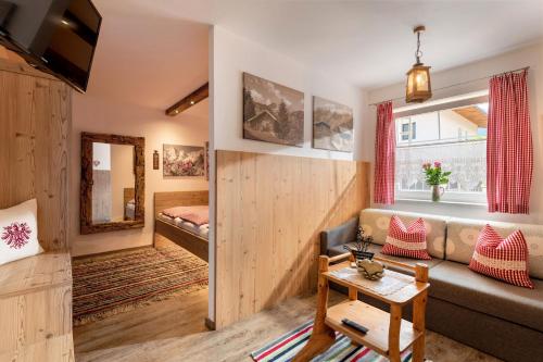a living room with a couch and a bed at Apart Silvana in Zell am Ziller