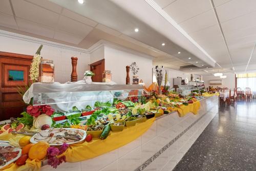 
a buffet table with many different types of food at Hotel Abrat in San Antonio
