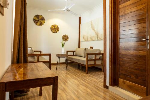 a living room with a wooden door and a couch at Mem Luxury Apartments and Hotel in Paje