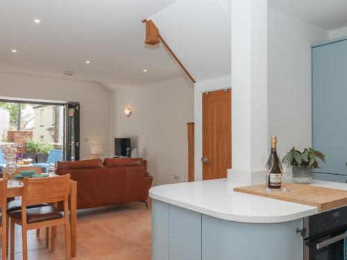 a kitchen and living room with a bottle of wine on a counter at Jams in Exmouth