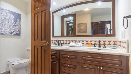 a bathroom with a sink and a mirror at The Great Escape Modern Oceanfront in Puerto Peñasco
