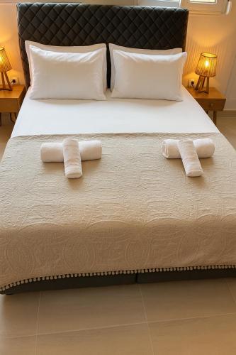 two towels on a bed with two pillows at Marcia's Welcome House in Rafina