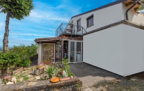 a house with a large window and a white garage at Cozy Apartment In Smarje With House Sea View in Šmarje