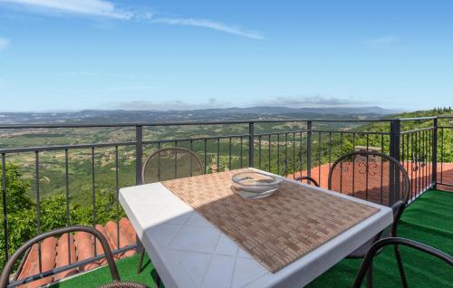 a table and chairs on a balcony with a view at Cozy Apartment In Smarje With House Sea View in Šmarje