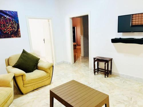 a living room with a couch and a coffee table at دار زمان Zaman Suites Old Town in Al Mafraq