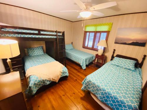 a bedroom with two bunk beds and a fan at Bayard avenue 1603 in Dewey Beach