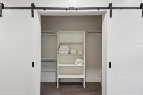 a closet with white walls and white shelves at Southwestern Charm | Espadin LoHi in Denver
