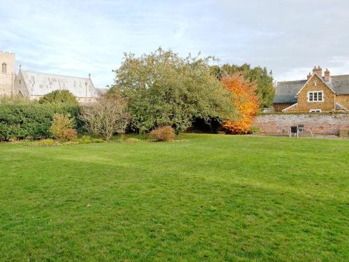 a large grassy yard with houses in the background at Church Haven in Hunstanton