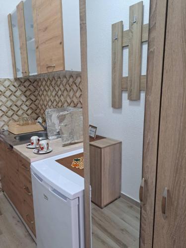 a kitchen with a counter and a washer and dryer at A-Niko Apartments in Vinica