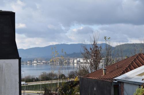 a view of a large body of water with buildings at Hostal Buenaventura in Valdivia