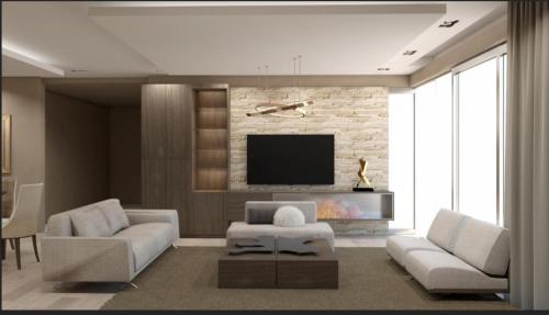 a living room with a couch and a tv at Sibauty Suites in La Paz
