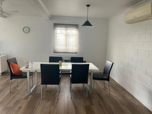 a dining room with a white table and chairs at Apartment in great location Murray Street in North Ward
