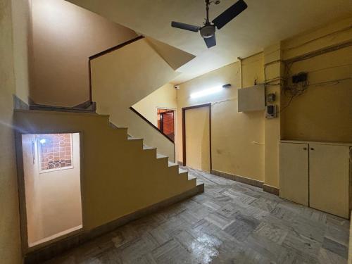 an empty room with a staircase and a door at JK Rooms 149 Thakur Galaxy in Nagpur