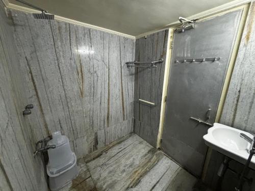 a bathroom with a shower and a toilet and a sink at JK Rooms 149 Thakur Galaxy in Nagpur