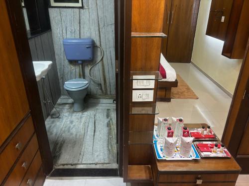 a bathroom with a toilet and a table with shoes at JK Rooms 149 Thakur Galaxy in Nagpur