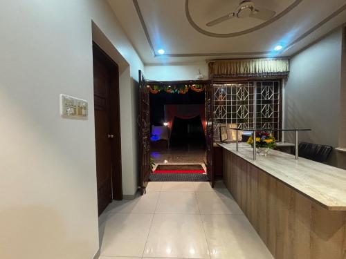 a hallway with a long counter and a room with a fireplace at JK Rooms 149 Thakur Galaxy in Nagpur