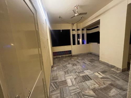 an empty room with a tile floor and a glass door at JK Rooms 149 Thakur Galaxy in Nagpur
