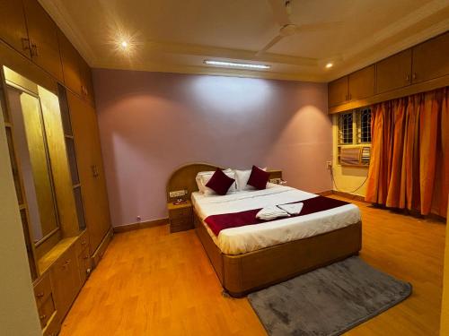 a bedroom with a large bed in a room at JK Rooms 149 Thakur Galaxy in Nagpur