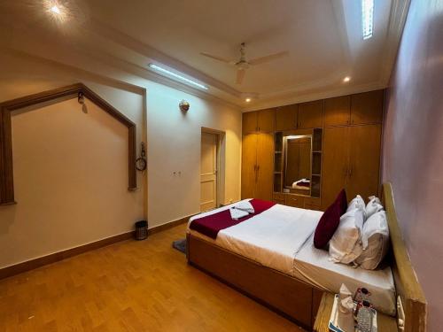 a bedroom with a large bed in a room at JK Rooms 149 Thakur Galaxy in Nagpur