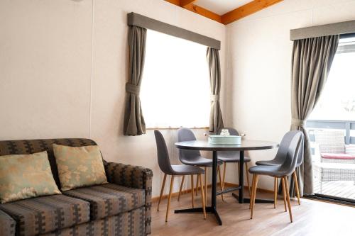 a living room with a couch and a table at Golden Country Motel and Caravan Park in Maryborough