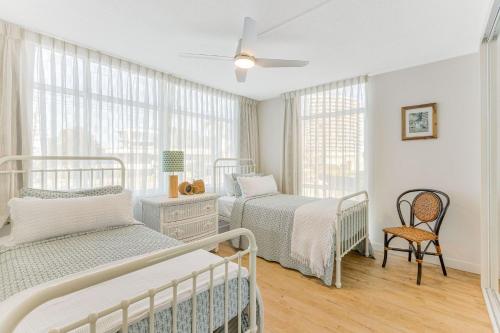 a bedroom with two beds and a ceiling fan at Beach Lodge Unit 5 in Gold Coast