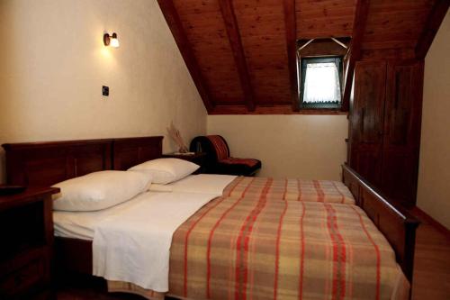a bedroom with a bed with a striped blanket and a window at Holiday home in Starigrad-Paklenica 41708 in Starigrad-Paklenica