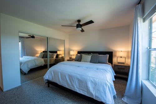 a bedroom with two beds and a ceiling fan at Hilltop Oasis in Templeton