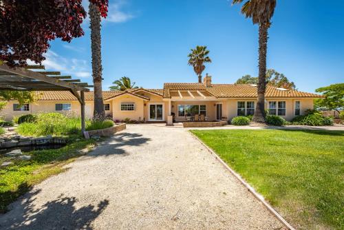 a house with palm trees in front of it at Hilltop Oasis in Templeton