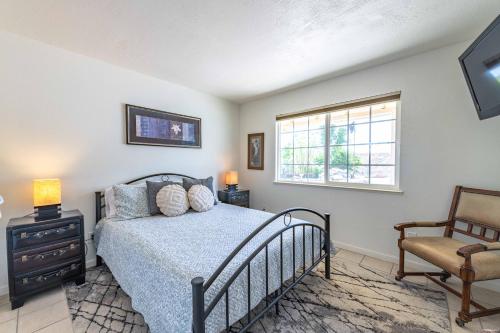 a bedroom with a bed and a window and a chair at Oak Pass Ranch in Paso Robles