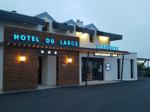 a hotel building with a large sign on it at Logis Hôtel du Large in Plougonvelin