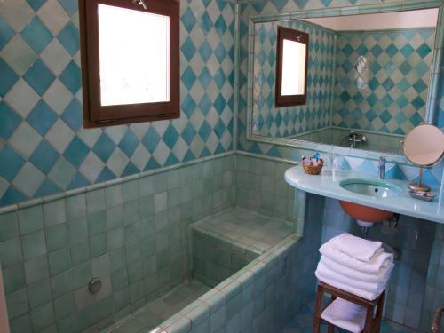 a bathroom with a tub and a sink and a shower at La Ferme Rose-Hôtel de Charme in Moustiers-Sainte-Marie